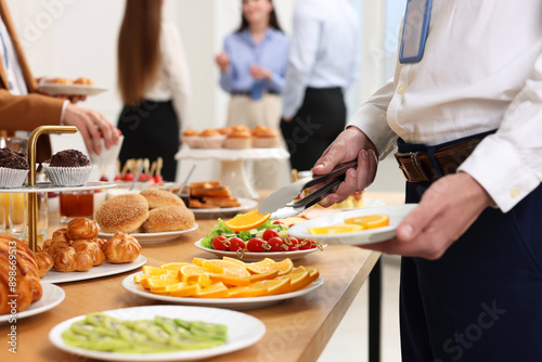 Coworkers having business lunch in restaurant, closeup