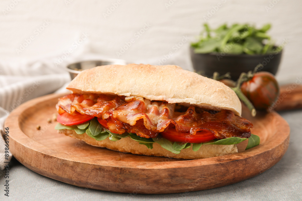 Tasty sandwich with bacon on grey table, closeup Tasty sandwich with bacon on grey table, closeup
