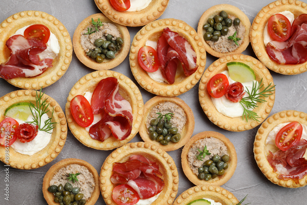 Different delicious canapes on grey textured table, flat lay Different delicious canapes on grey textured table, flat lay
