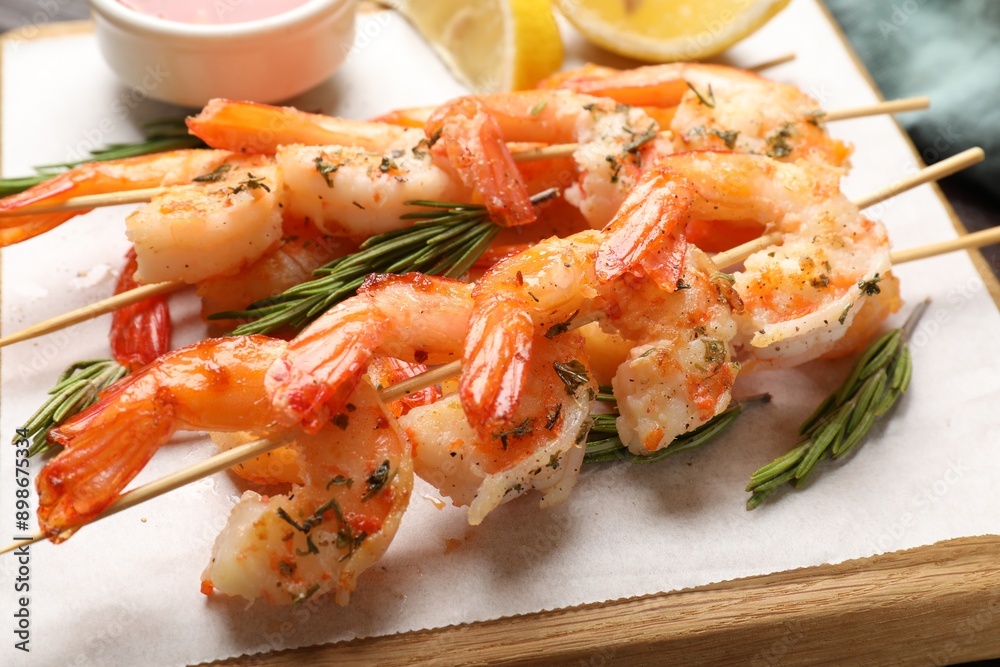 Skewers with delicious grilled shrimps on table, closeup Skewers with delicious grilled shrimps on table, closeup