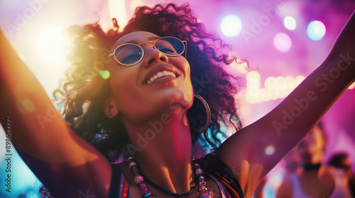 Joyful woman dancing at colorful night party, wearing sunglasses, experiencing fun and freedom, neon lights, happiness, nightlife, celebration, joy concept photo