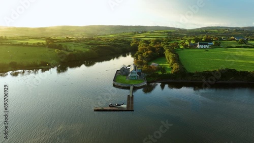 Magnificent lake viewhouse by the river green fields and fog over the river boat photo