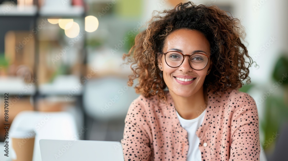 A woman with curly hair and glasses in a polka-dot cardigan smiling brightly while sitting in a modern cafe, embodying a relaxed and joyful moment in a stylish setting. A woman with curly hair and glasses in a polka-dot cardigan smiling brightly while sitting in a modern cafe, embodying a relaxed and joyful moment in a stylish setting.