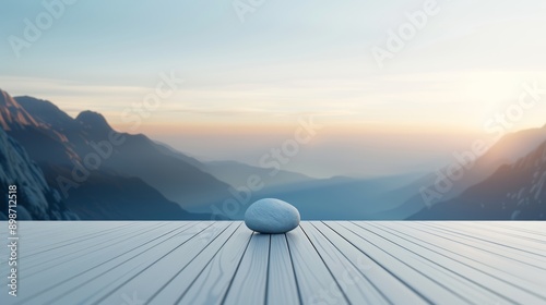 A serene landscape showcasing a calm stone on a wooden deck, with majestic mountains and a colorful sunset in the background. photo