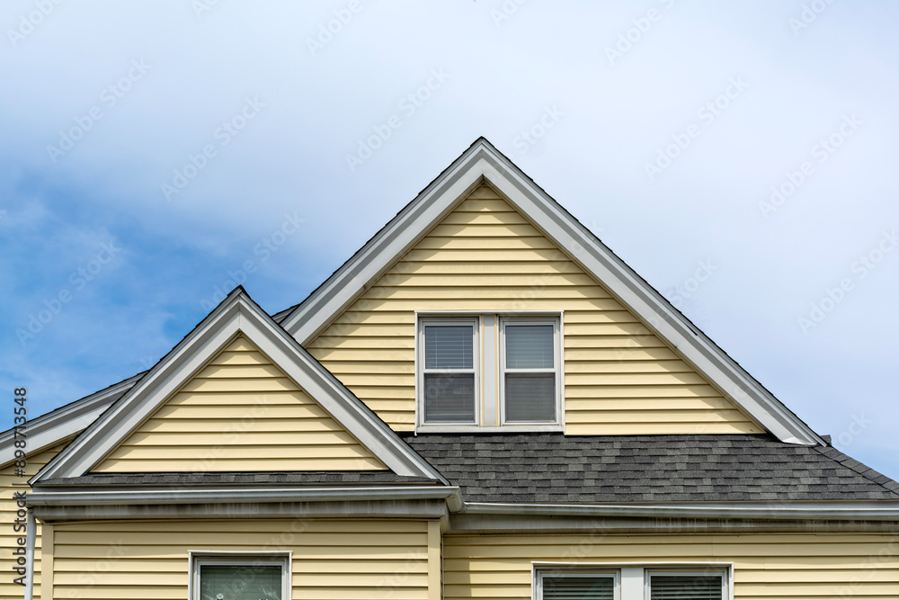 Yellow Family House with Cross Gable Roof in Brighton, Massachusetts, USA Yellow Family House with Cross Gable Roof in Brighton, Massachusetts, USA
