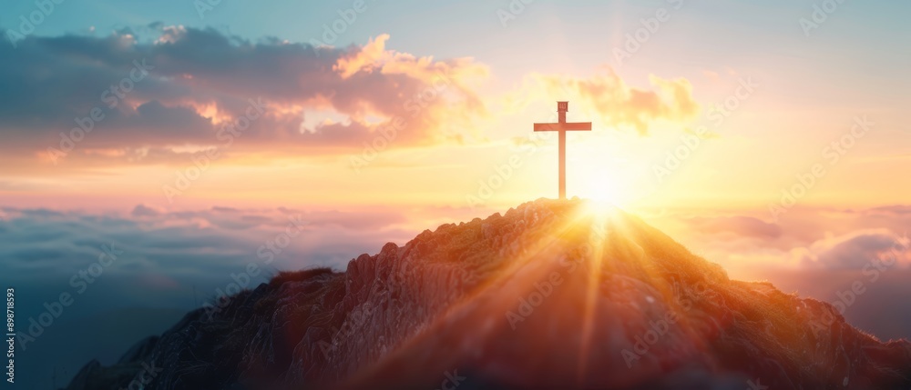 A sunset scene with a mountain topped by a cross, adorned with clouds in the foreground A sunset scene with a mountain topped by a cross, adorned with clouds in the foreground