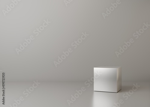 Reflective metal cube in empty gray room. Abstract minimal scene for product stage showcase.