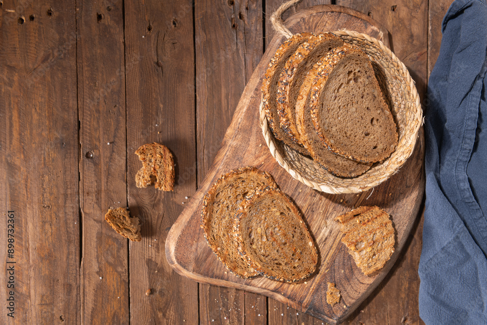 Whole Grain rye bread with seeds on a wooden board. Top view Whole Grain rye bread with seeds on a wooden board. Top view