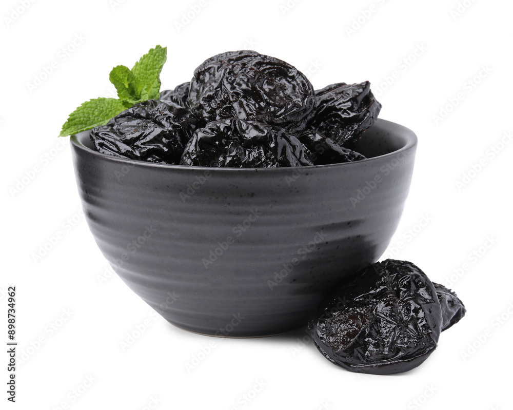 Tasty dried plums (prunes) and mint leaves in bowl on white background Tasty dried plums (prunes) and mint leaves in bowl on white background