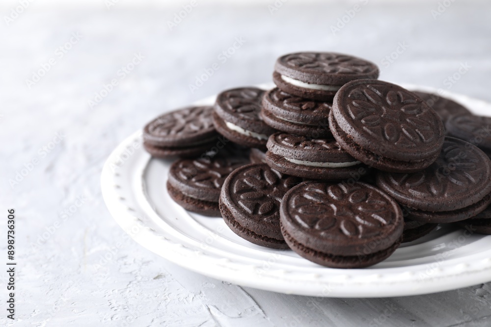 Many tasty sandwich cookies on light grey table Many tasty sandwich cookies on light grey table