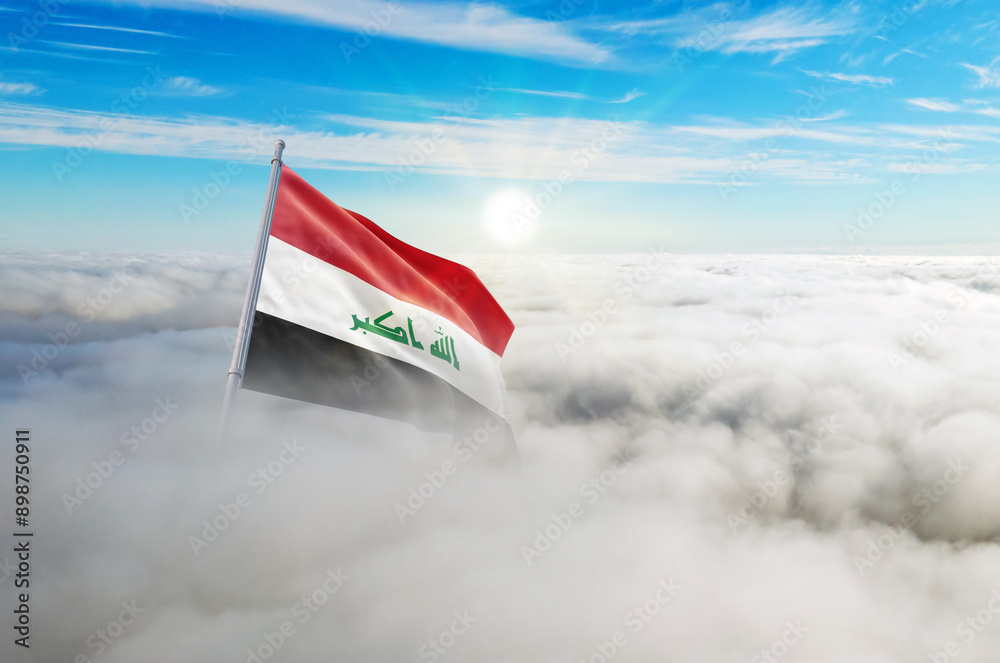 Naklejka premium Iraq flag aerial view in beautiful sky with clouds. Top-down drone shot at sunrise or sunset. Aerial bird's eye view of the flag with cloudscape.