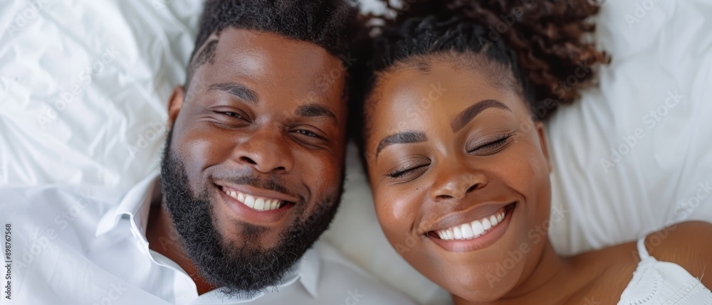 A man and a woman lie on a bed with their eyes closed; one woman keeps hers shut A man and a woman lie on a bed with their eyes closed; one woman keeps hers shut