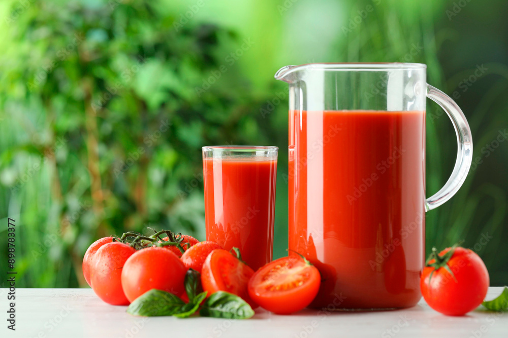 Tasty tomato juice, basil and fresh vegetables on white table outdoors Tasty tomato juice, basil and fresh vegetables on white table outdoors