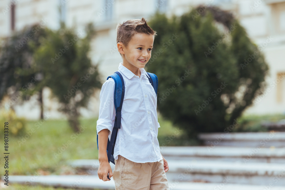 A cheerful Caucasian boy with a backpack strides confidently towards school, dressed in smart casual attire, radiating excitement for a new day of learning. A cheerful Caucasian boy with a backpack strides confidently towards school, dressed in smart casual attire, radiating excitement for a new day of learning.