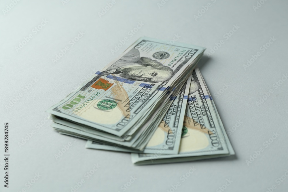 Dollar banknotes on grey background, closeup. American currency Dollar banknotes on grey background, closeup. American currency