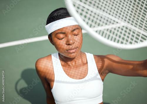 Fototapeta Naklejka Na Ścianę i Meble -  Black woman, relax and racket for tennis on court with sunshine protection, training and sports workout. African, female athlete, uv security and vitamin d of natural heat for exercise of competition