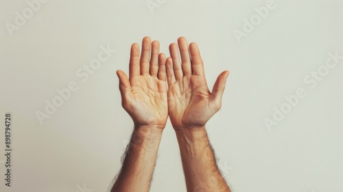 Two male hands raised up