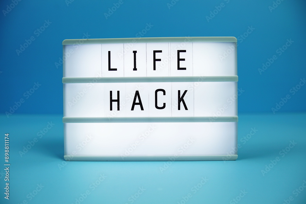 Life Hacks letterboard text on LED Lightbox on blue background Life Hacks letterboard text on LED Lightbox on blue background