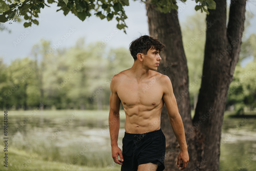 Athletic young man exercising shirtless in a park, showcasing physical fitness and wellness in a natural environment. Athletic young man exercising shirtless in a park, showcasing physical fitness and wellness in a natural environment.