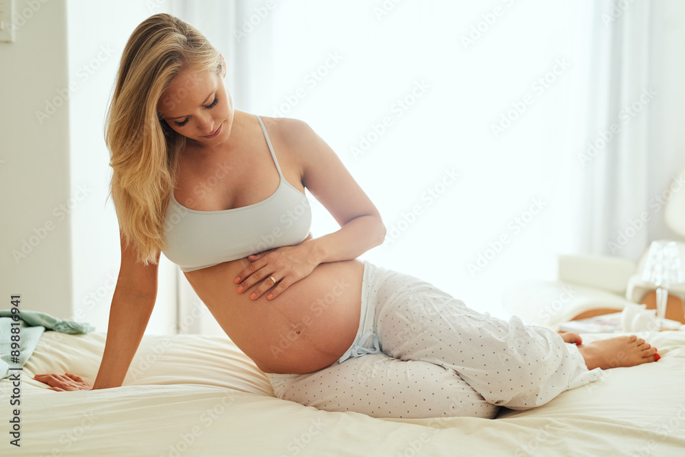 Woman, pregnancy and relax on bed in morning for wellness, development and growth of baby. Mother or mom, stomach and health or peace in home or apartment with love, care and ivf therapy for family