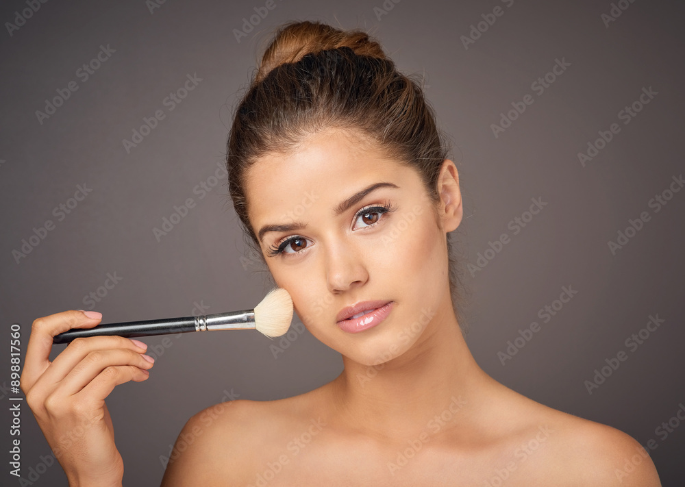 Obraz premium Brush, beauty and portrait of woman in studio for wellness, makeup and cosmetics on gray background. Cosmetology, attractive and face of girl with tools for application, foundation and skincare