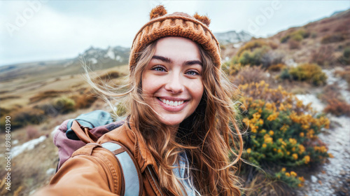 A young woman with long, flowing hair smiles while wearing a bro