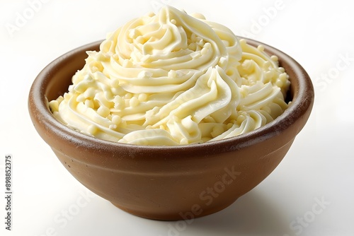 White frosting in a brown bowl photo