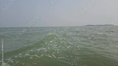 Slow motion side view of sea surface from a boat at Chilika Lake. Odisha state on the east coast of India. photo