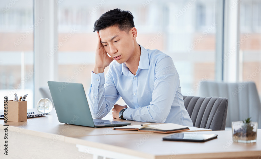 Business, man and laptop with headache in office for deadline stress, burnout and overworked at desk. Professional, chinese person and migraine with anxiety for stock market crash and trading mistake Business, man and laptop with headache in office for deadline stress, burnout and overworked at desk. Professional, chinese person and migraine with anxiety for stock market crash and trading mistake