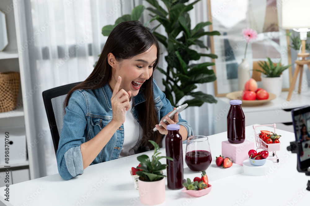 Smiling young beautiful Asian reviewing tasty mixed strawberry and cherry juice detox drinks, showing healthy product to promote for special promotion selling on social media online record. Stratagem. Smiling young beautiful Asian reviewing tasty mixed strawberry and cherry juice detox drinks, showing healthy product to promote for special promotion selling on social media online record. Stratagem.