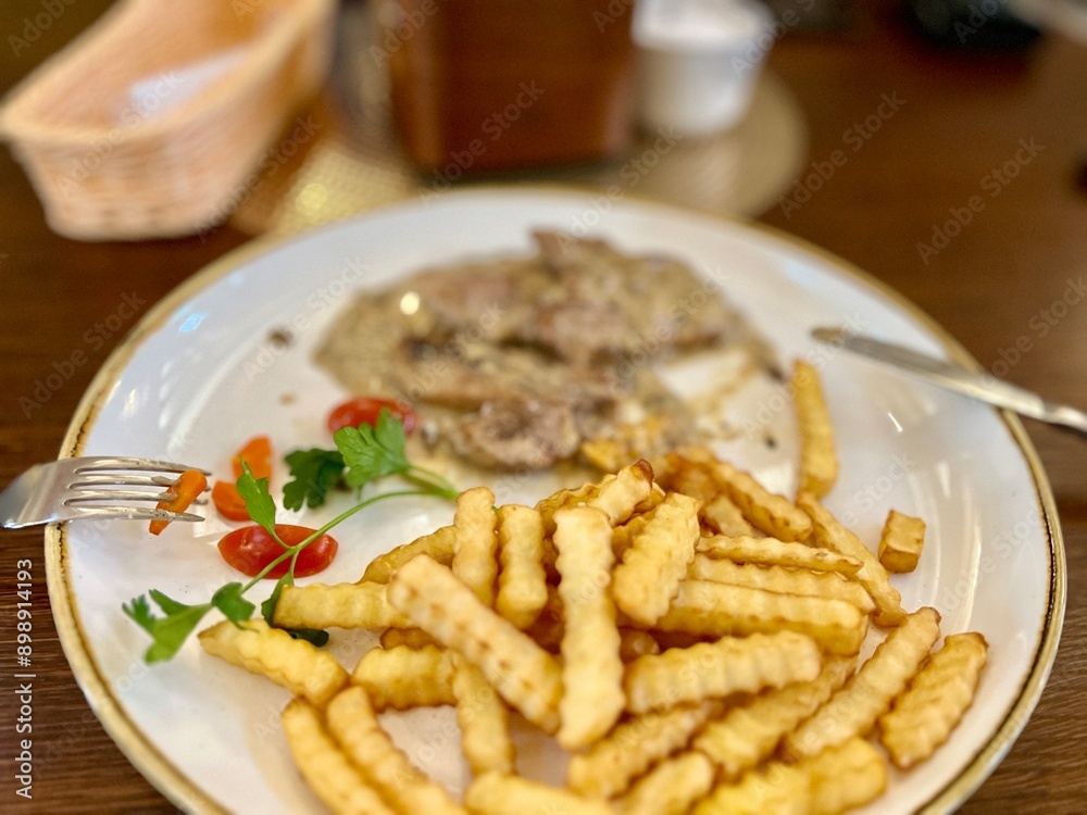 steak with french fries on a plate in a restaurant, selective focus steak with french fries on a plate in a restaurant, selective focus