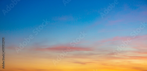 Beautiful Vivid sky painted by the sun leaving bright golden shades.Dense clouds in twilight sky in winter evening.Image of cloud sky on evening time.Evening Vivid sky with clouds