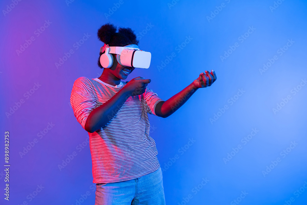 Hunting African gamer wearing VR turning metaverse world playing gun shooting hunter isolate blue neon light connect victory animal hunting futuristic technology hologram virtual reality. Contrivance. Hunting African gamer wearing VR turning metaverse world playing gun shooting hunter isolate blue neon light connect victory animal hunting futuristic technology hologram virtual reality. Contrivance.
