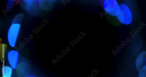 Blue circle portal bokeh prism background texture against black