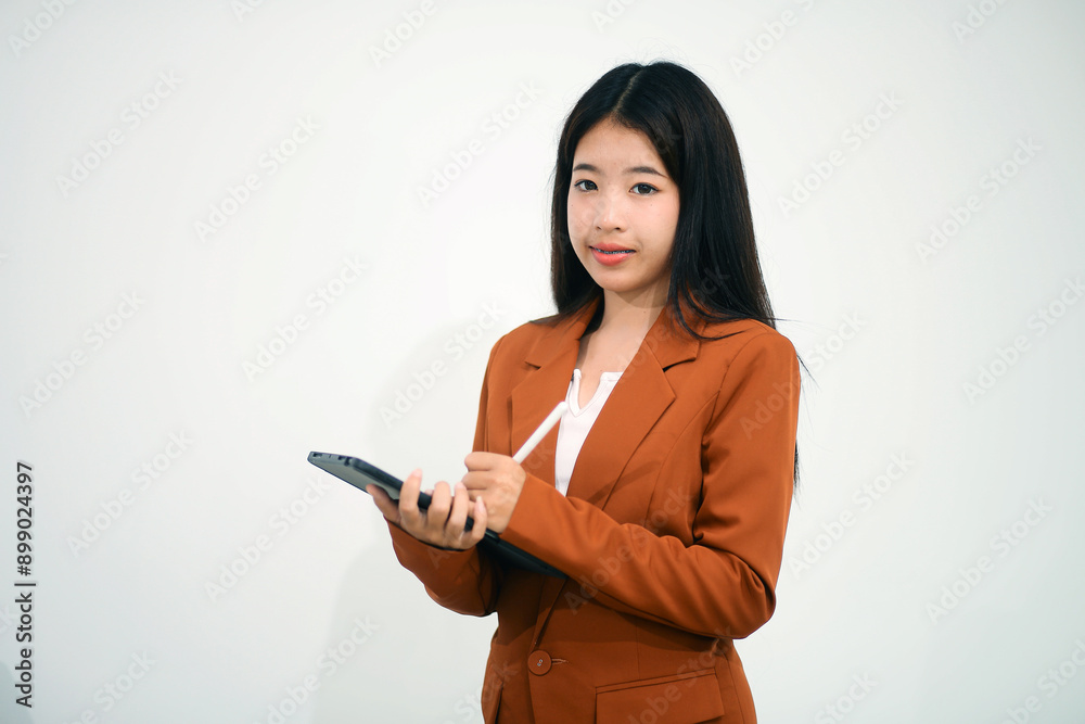 Young beautiful Asian woman in business office standing use tablet in hand, Thai girl enjoy browsing for online shopping store with copy space for advertisement, on isolated white background Young beautiful Asian woman in business office standing use tablet in hand, Thai girl enjoy browsing for online shopping store with copy space for advertisement, on isolated white background
