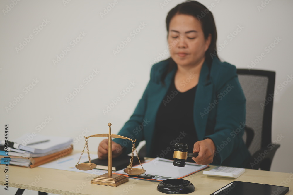Pretty Asian female lawyer working and hammer, laptop, justice advice and legal concept. In office Pretty Asian female lawyer working and hammer, laptop, justice advice and legal concept. In office