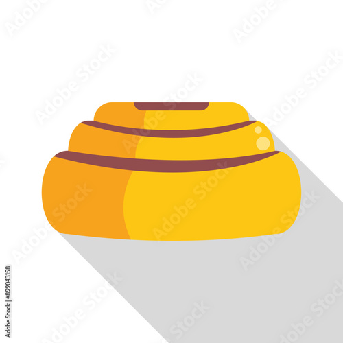 Delicious cinnamon roll with icing is lying on its side and casting a long shadow