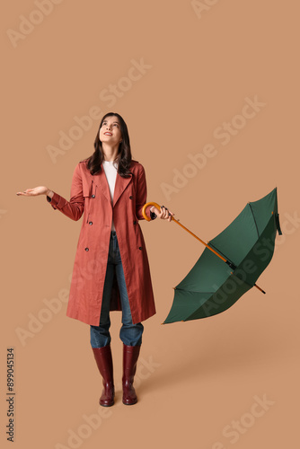 Young woman with opened umb...