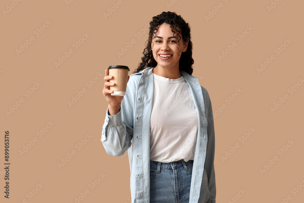 Beautiful young African-American woman in stylish collar shirt with paper cup of coffee on brown background Beautiful young African-American woman in stylish collar shirt with paper cup of coffee on brown background