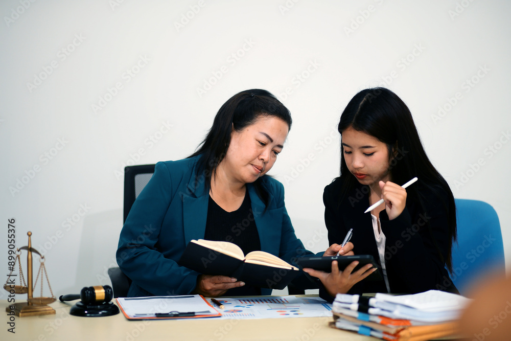 Pretty Asian female lawyer working and hammer, laptop, justice advice and legal concept. In office Pretty Asian female lawyer working and hammer, laptop, justice advice and legal concept. In office