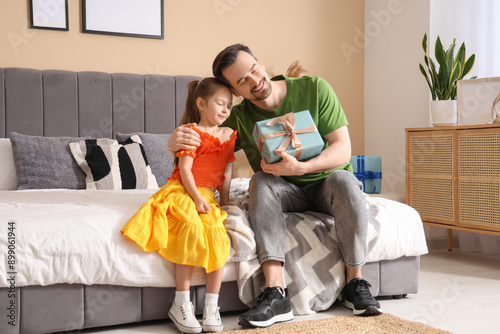 Little daughter giving fath...