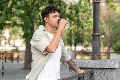 Handsome young man drinking...