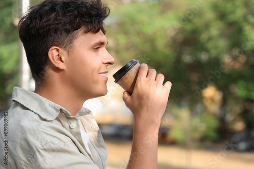 Handsome young man drinking...