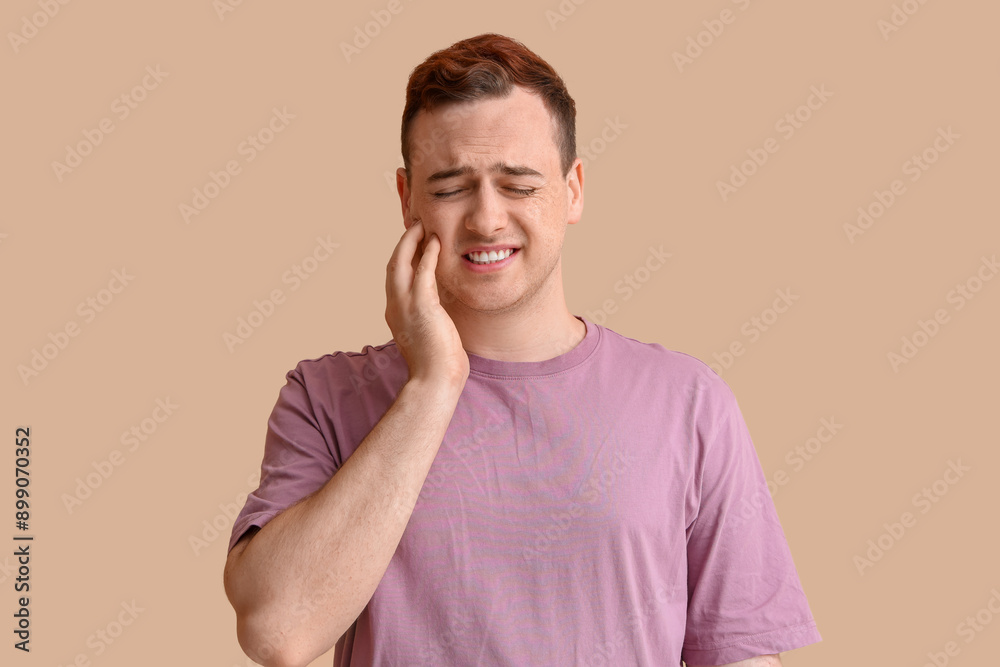Young man suffering from tooth ache on beige background Young man suffering from tooth ache on beige background