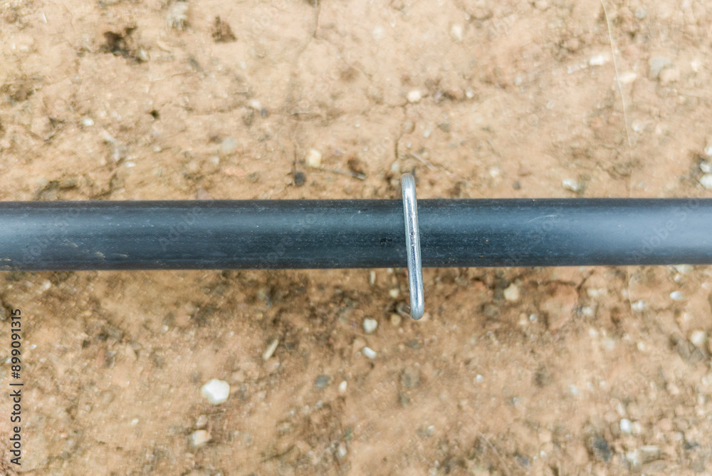 U pins or hold down pegs installed over pipe