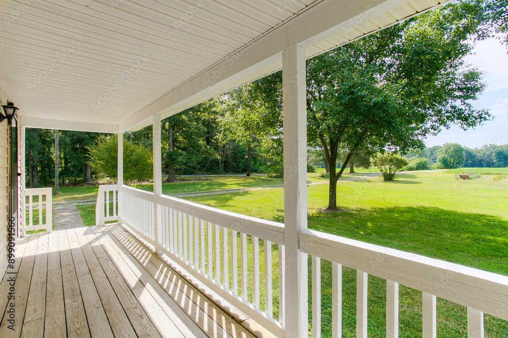 Charming Front Porch With Expansive Yard View And White Railing Charming Front Porch With Expansive Yard View And White Railing