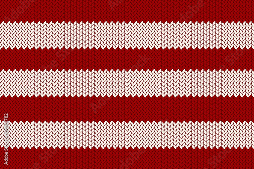 Texture of knitted fabric. Cozy knitting pattern in red and white horizontal stripes