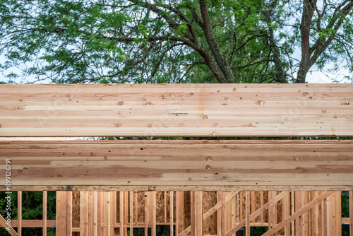 Quadro su tela Closeup detail of new house construction, wall wood framing started and glue lam