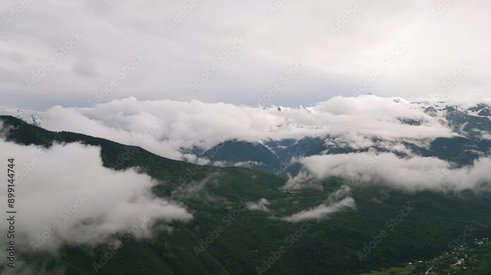 Aerial view above clouds over Svaneti mountains, Mazeri village. Dramatic scenery of lush green hills. Mist floating over peaks. Ideal for nature, travel, eco-related content. Drone shot Aerial view above clouds over Svaneti mountains, Mazeri village. Dramatic scenery of lush green hills. Mist floating over peaks. Ideal for nature, travel, eco-related content. Drone shot