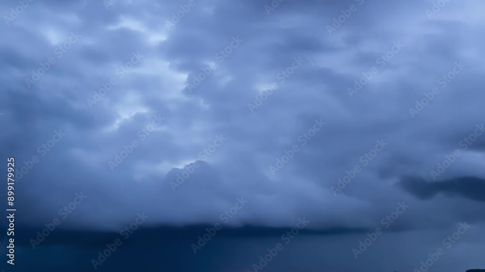 A thrilling hyperlapse shot of a thunderstorm brewing with lightning illuminating the dark sky and rain clouds moving in. A thrilling hyperlapse shot of a thunderstorm brewing with lightning illuminating the dark sky and rain clouds moving in.